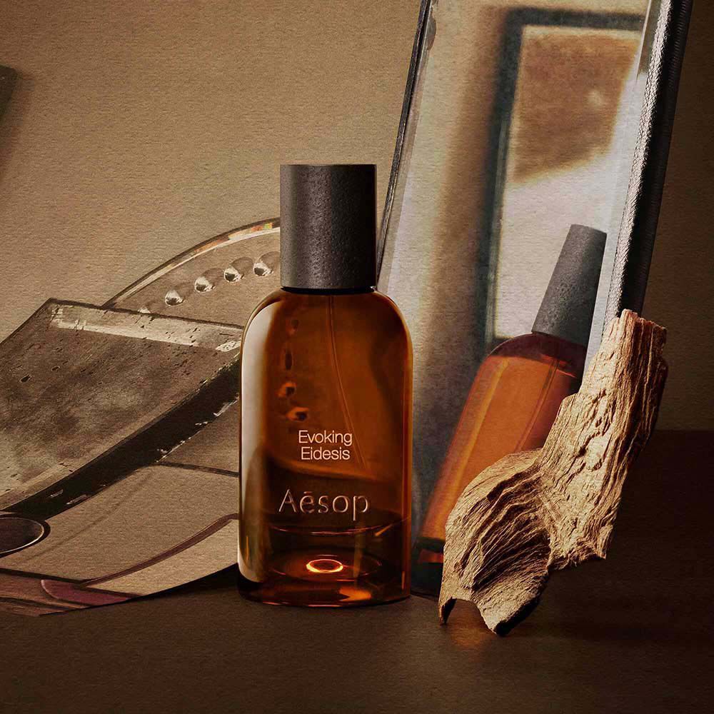 Aesop Evoking Eidesis bottle with a tube and piece of wood on mirrored trays.