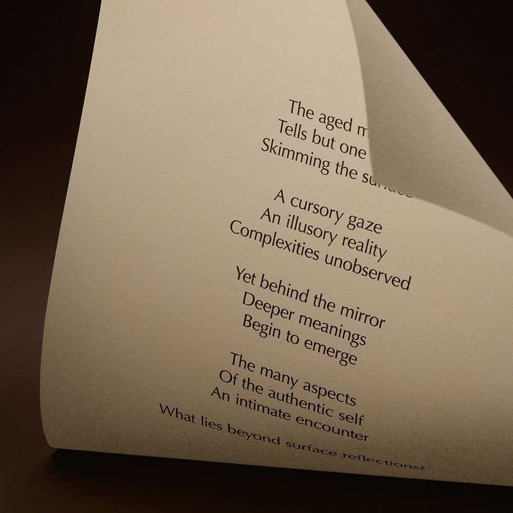 Curved cream page with printed verse against a dark brown background.